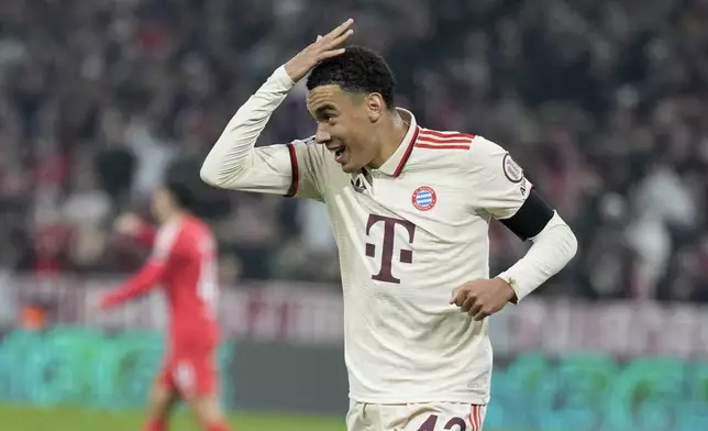 Bayern's Jamal Musiala celebrates after scoring the opening goal during the Champions League opening phase soccer match between Bayern Munich and SL Benfica, in Munich, Germany, Wednesday, Nov. 6, 2024. (AP Photo/Matthias Schrader)