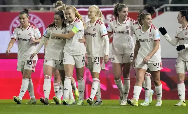 Bayern's Sarah Zadrazil, second left, is congratulated by teammate Glodis Viggosdottir after scoring her side's third goal during the women's Champions League group C soccer match between FC Bayern Munich and Valerenga at the FC Bayern Campus in Munich, Germany, Tuesday, Nov. 12, 2024. (AP Photo/Matthias Schrader)