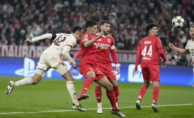 Bayern's Jamal Musiala, left, scores the opening goal during the Champions League opening phase soccer match between Bayern Munich and SL Benfica, in Munich, Germany, Wednesday, Nov. 6, 2024. (AP Photo/Matthias Schrader)