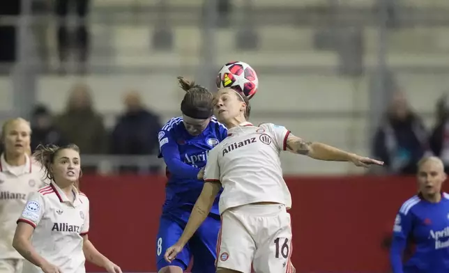 Bayern's Julia Zigotti Olme jumps for the ball with Valerenga's Linn Vickius, background, during the women's Champions League group C soccer match between FC Bayern Munich and Valerenga at the FC Bayern Campus in Munich, Germany, Tuesday, Nov. 12, 2024. (AP Photo/Matthias Schrader)