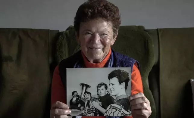 Solveig Leo, 81, former head of a large state-owned farm shows an old photo of herself from her youth during her interview with the Associated Press in the northeastern village of Banzkow, Germany, Monday, Oct. 28, 2024. (AP Photo/Ebrahim Noroozi)