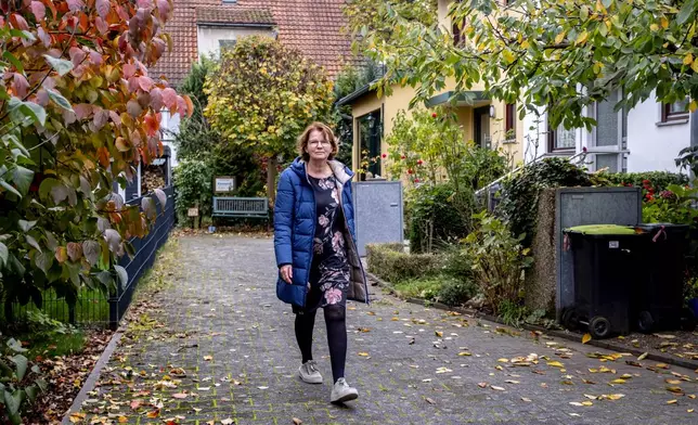 Claudia Huth walks in front of her house in Egelsbach, Germany, Thursday, Oct. 31, 2024. (AP Photo/Michael Probst)