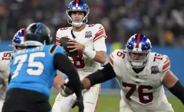 New York Giants quarterback Daniel Jones plays against the Carolina Panthers during the second half of an NFL football game, Sunday, Nov. 10, 2024, in Munich, Germany. (AP Photo/Matthias Schrader)