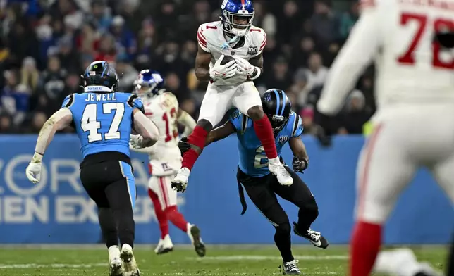 New York Giants wide receiver Malik Nabers catches a pass against the Carolina Panthers during the second half of an NFL football game, Sunday, Nov. 10, 2024, in Munich, Germany. (AP Photo/Lennart Preiss)