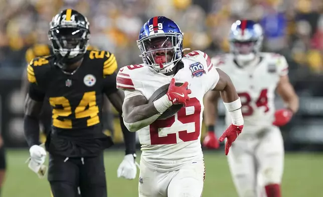 New York Giants running back Tyrone Tracy Jr. (29) runs for a touchdown during the second half of an NFL football game against the Pittsburgh Steelers, Monday, Oct. 28, 2024, in Pittsburgh. (AP Photo/Matt Freed)