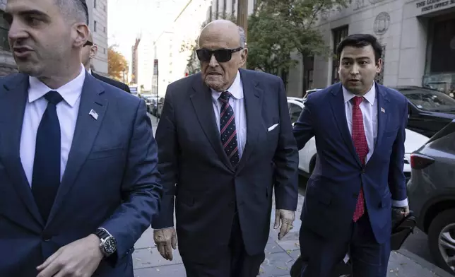 Former New York City Mayor Rudy Giuliani arrives at the court to explain to a federal judge why he hasn't surrendered his valuables as part of a $148 million defamation judgment, in New York, Thursday, Nov. 7, 2024. (AP Photo/Yuki Iwamura)