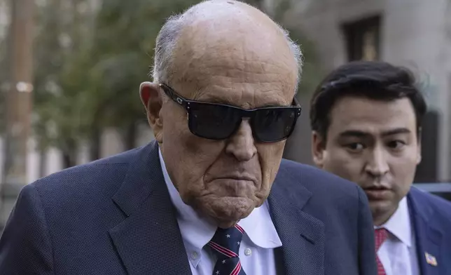 Former New York City Mayor Rudy Giuliani arrives at the court to explain to a federal judge why he hasn't surrendered his valuables as part of a $148 million defamation judgment, in New York, Thursday, Nov. 7, 2024. (AP Photo/Yuki Iwamura)