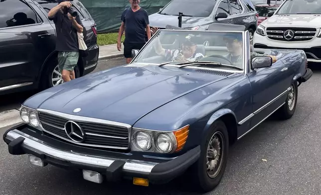 This photo provided by the Financial Times shows Rudy Giuliani in the passenger seat of a Mercedes convertible at the same polling place where Donald Trump cast his ballot on Election Day, Tuesday, Nov. 5, 2024, in Palm Beach, Fla. (Alex Rogers/Financial Times via AP)