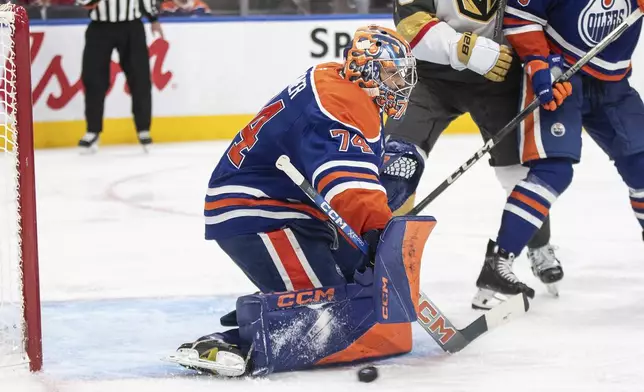 Edmonton Oilers' goalie Stuart Skinner (74) makes a save against the Vegas Golden Knights during the third period of an NHL hockey game Wednesday, Nov. 6, 2024 in Edmonton, Alberta. (Jason Franson/The Canadian Press via AP)