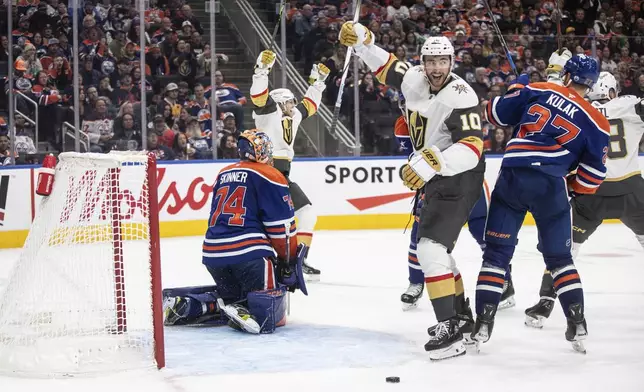 Vegas Golden Knights' William Karlsson (back left) and Nicolas Roy (10) react as the puck goes in for a goal against Edmonton Oilers goalie Stuart Skinner (74) during third period NHL action in Edmonton on Wednesday, November 6, 2024. (Jason Franson/The Canadian Press via AP)