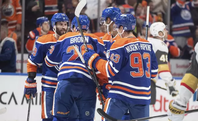 Edmonton Oilers' Adam Henrique, left to right, Connor Brown, Darnell Nurse and Ryan Nugent-Hopkins celebrate a goal against the Vegas Golden Knights during the second period of an NHL hockey game Wednesday, Nov. 6, 2024 in Edmonton, Alberta. (Jason Franson/The Canadian Press via AP)