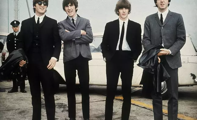 FILE - The Beatles, from left, John Lennon, George Harrison, Ringo Starr and Paul McCartney appear in Liverpool, England on July 10, 1964, for the premiere of their movie "A Hard Day's Night." (AP Photo, File)