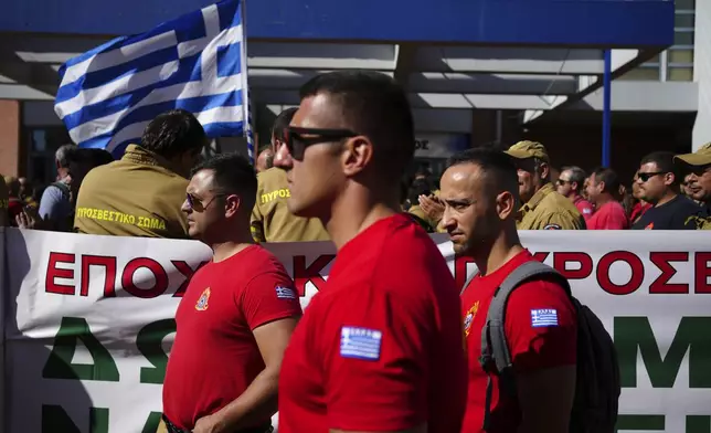 Hundreds of seasonal firefighters attend a protest outside Greece's Civil Protection Ministry to demand year-round contracts, in Athens, Thursday Oct. 31, 2024. (AP Photo/Thanassis Stavrakis)