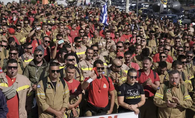 Hundreds of seasonal firefighters attend a protest outside Greece's Civil Protection Ministry to demand year-round contracts, in Athens, Thursday Oct. 31, 2024. (AP Photo/Thanassis Stavrakis)