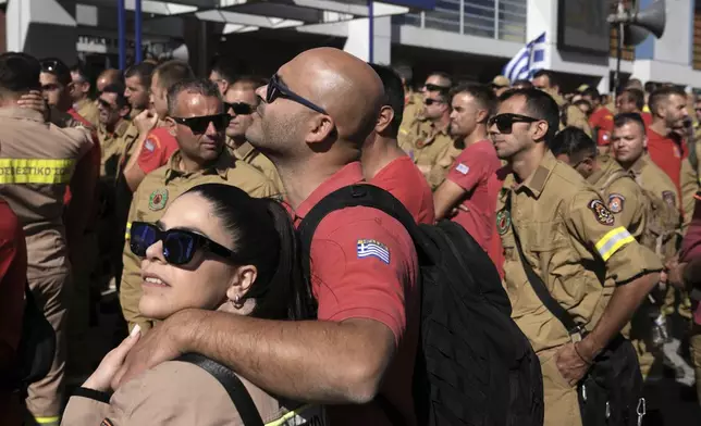 Hundreds of seasonal firefighters attend a protest outside Greece's Civil Protection Ministry to demand year-round contracts, in Athens, Thursday Oct. 31, 2024. (AP Photo/Thanassis Stavrakis)