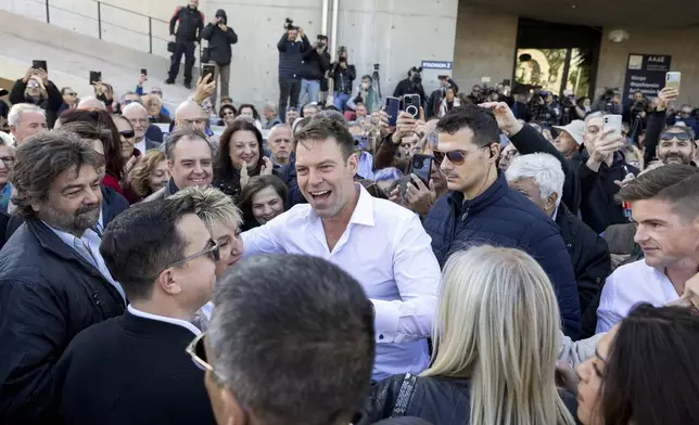 Stefanos Kasselakis, center, a political neophyte who led main opposition SYRIZA party for a year following a stinging election defeat in 2023, is cheered by supporters ahead of an announcement for a new political formation, in Athens, Greece, Saturday, Nov. 9, 2024. (AP Photo/Yorgos Karahalis)