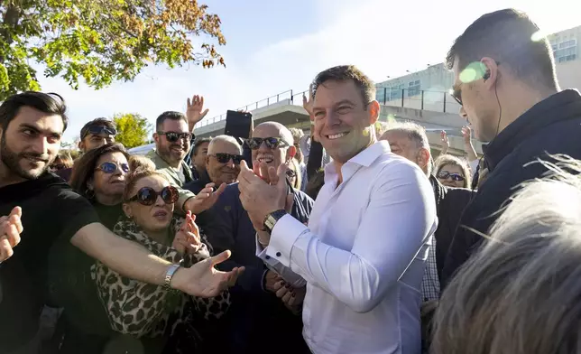 Stefanos Kasselakis, center, a political neophyte who led main opposition SYRIZA party for a year following a stinging election defeat in 2023, is cheered by supporters ahead of an announcement for a new political formation, in Athens, Greece, Saturday, Nov. 9, 2024. (AP Photo/Yorgos Karahalis)