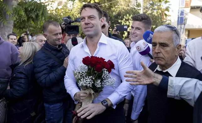 Stefanos Kasselakis, center, a political neophyte who led main opposition SYRIZA party for a year following a stinging election defeat in 2023, is cheered by supporters ahead of an announcement for a new political formation, in Athens, Greece, Saturday, Nov. 9, 2024. (AP Photo/Yorgos Karahalis)
