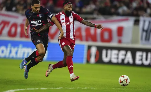 Olympiacos' Rodinei, right, runs for the ball with Rangers' Cyriel Dessers during the Europa League opening phase soccer match between Olympiacos and Rangers at the Georgios Karaiskakis stadium at Athens' port of Piraeus, Greece, Thursday, Nov. 7, 2024. (AP Photo/Thanassis Stavrakis)