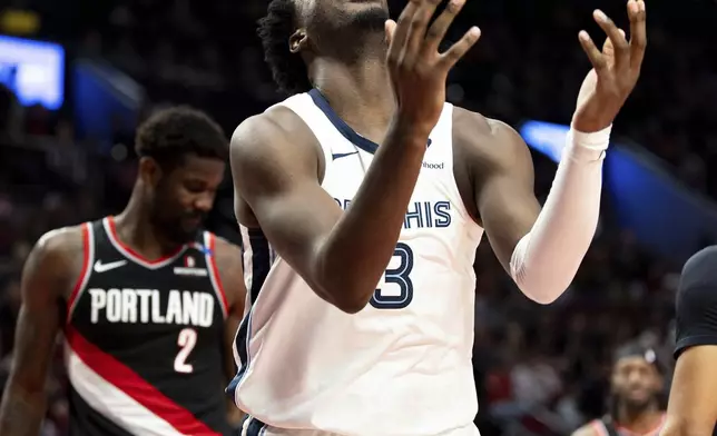 Memphis Grizzlies forward Jaren Jackson Jr., middle, reacts to the foul call against Portland Trail Blazers during the second half of an NBA basketball game, Sunday, Nov. 10, 2024, in Portland, Ore. (AP Photo/Howard Lao)