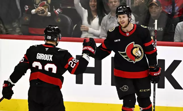 Ottawa Senators defenceman Nick Jensen (3) celebrates his goal against the New York Islanders with right wing Claude Giroux (28) during third period NHL hockey action in Ottawa, on Thursday, Nov. 7, 2024. THE CANADIAN PRESS/Justin Tang/The Canadian Press via AP)