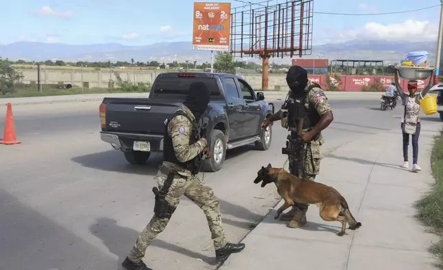 Police officers patrol near the Toussaint Louverture International Airport in Port-au-Prince, Haiti, Tuesday, Nov. 12, 2024. (AP Photo/Odelyn Joseph)