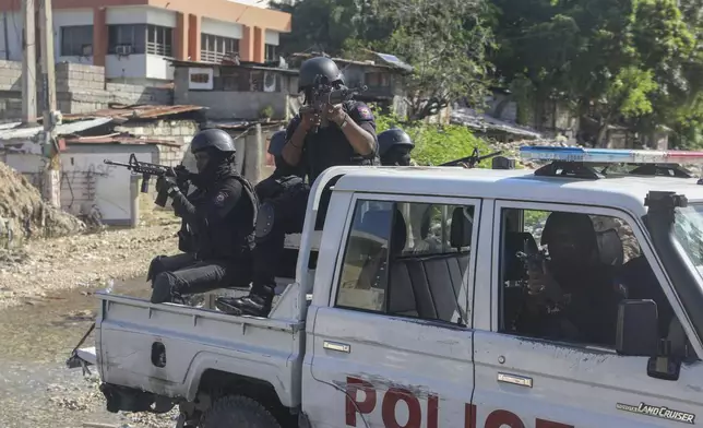 Police officers patrol the area during an exchange of gunfire between gangs and police in Port-au-Prince, Haiti, Monday, Nov. 11, 2024. (AP Photo/Odelyn Joseph)