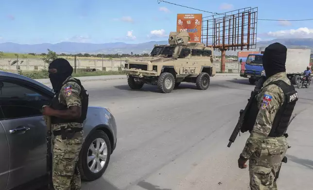 Police officers patrol near the Toussaint Louverture International Airport in Port-au-Prince, Haiti, Tuesday, Nov. 12, 2024. (AP Photo/Odelyn Joseph)