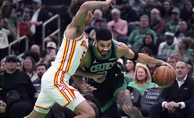 Boston Celtics forward Jayson Tatum drives to the basket against Atlanta Hawks guard Dyson Daniels during the first half of an Emirates NBA Cup basketball game, Tuesday, Nov. 12, 2024, in Boston. (AP Photo/Charles Krupa)