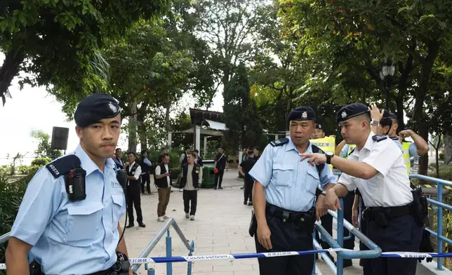 Police officers cordon off an area where a Southeast Asian woman's body was found Monday at a waterfall inside a park in Hong Kong, Wednesday, Oct. 30, 2024. (AP Photo/Bertha Wang)