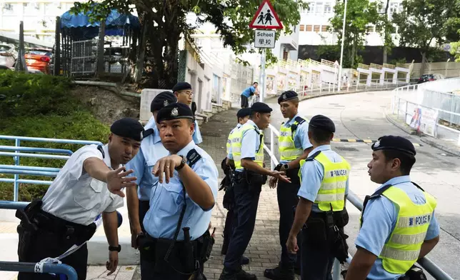 Police officers cordon off an area where a Southeast Asian woman's body was found Monday at a waterfall inside a park in Hong Kong, Wednesday, Oct. 30, 2024. (AP Photo/Bertha Wang)