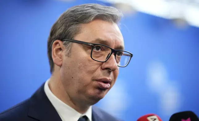 Serbia's President Aleksander Vucic speaks with the media as he arrives for the European Political Community (EPC) Summit at the Puskas Arena in Budapest, Hungary, Thursday, Nov. 7, 2024. (AP Photo/Petr Josek)