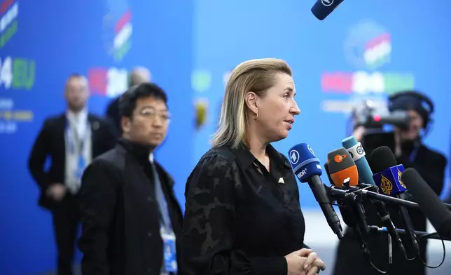 Denmark's Prime Minister Mette Frederiksen speaks with the media as she arrives for an EU Summit at the Puskas Arena in Budapest, Hungary, Friday, Nov. 8, 2024. (AP Photo/Petr David Josek)