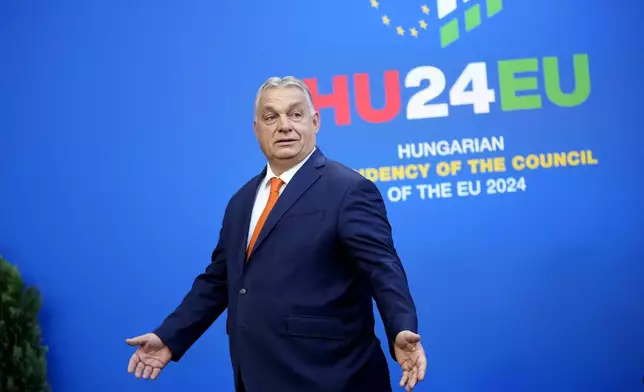 Hungary's Prime Minister Viktor Orban gestures during arrivals for an EU Summit at the Puskas Arena in Budapest, Hungary, Friday, Nov. 8, 2024. (AP Photo/Petr David Josek)