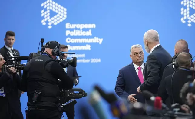 Albania's Prime Minister Edi Rama, right, speaks with Hungary's Prime Minister Viktor Orban, center, as he arrives for the European Political Community (EPC) Summit at the Puskas Arena in Budapest, Hungary, Thursday, Nov. 7, 2024. (AP Photo/Petr Josek)