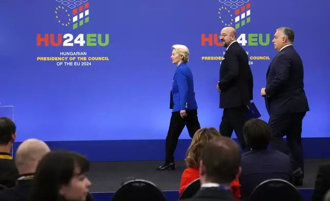 From left, European Commission President Ursula von der Leyen, European Council President Charles Michel and Hungary's Prime Minister Viktor Orban arrive for a media conference at the end of an EU Summit at the Puskas Arena in Budapest, Hungary, Friday, Nov. 8, 2024. (AP Photo/Petr David Josek)