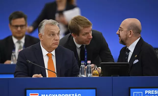 Hungary's Prime Minister Viktor Orban, left, and European Council President Charles Michel, right, wait for the start of a plenary session during an EU Summit at the Puskas Arena in Budapest, Friday, Nov. 8, 2024. (AP Photo/Denes Erdos)