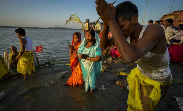 Hindu devotees gather by the river Brahmaputra and offer prayers during Chhath Puja festival in Guwahati, northeastern Assam state, India, Thursday, Nov. 7, 2024. (AP Photo/Anupam Nath)