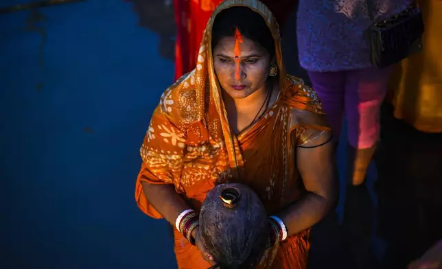 A Hindu devotee offers prayers at the river Brahmaputra during Chhath Puja festival in Guwahati, northeastern Assam state, India, Thursday, Nov. 7, 2024. (AP Photo/Anupam Nath)