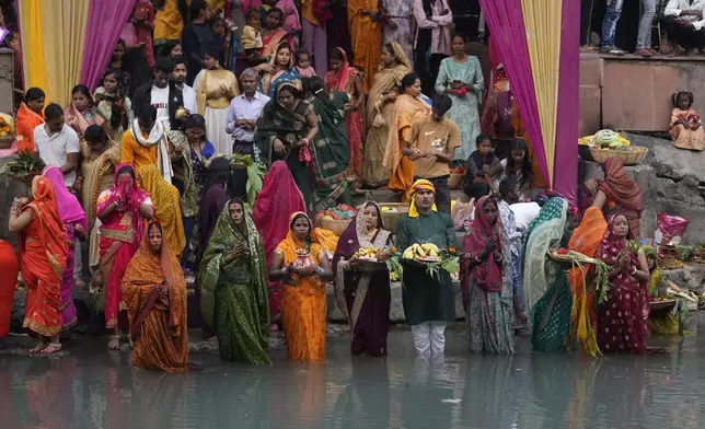 Hindu devotees perform rituals at sunset on the Ranbir canal during Chhath Puja festival in Jammu, India, Thursday, Nov. 7, 2024. (AP Photo/Channi Anand)