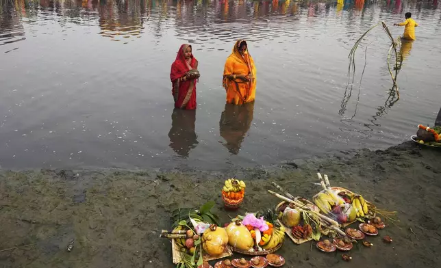 Women devotees offer prayers to the sun god on the banks of the river Yamuna during the Chhath festival in Noida, near New Delhi, India, Thursday, Nov. 7, 2024. (AP Photo/Manish Swarup)