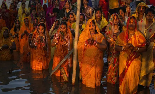 Hindu devotees gather by the river Brahmaputra and offer prayers to the setting sun during Chhath festival in Guwahati, northeastern Assam state, India, Thursday, Nov. 7, 2024. (AP Photo/Anupam Nath)