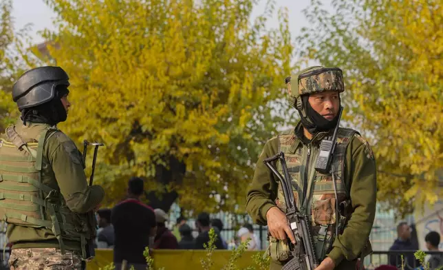 Indian paramilitary soldiers guard at the site of a grenade explosion at a marketplace, in Srinagar, Indian controlled Kashmir, Sunday, Nov. 3, 2024. (AP Photo/Mukhtar Khan)