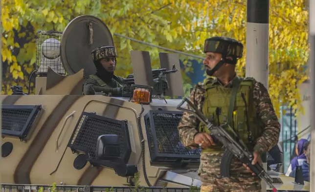 Indian paramilitary soldiers guard at the site of a grenade explosion at a marketplace, in Srinagar, Indian controlled Kashmir, Sunday, Nov. 3, 2024. (AP Photo/Mukhtar Khan)