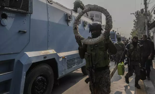 Indian paramilitary soldiers move towards the site of a gun battle, in Srinagar, Indian controlled Kashmir, Saturday, Nov. 2, 2024. (AP Photo/Mukhtar Khan)