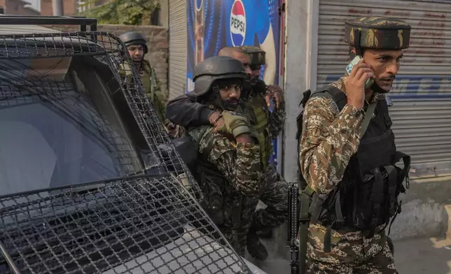 An injured Indian paramilitary soldier is taken to hospital for treatment, during the gun battle, in Srinagar, Indian controlled Kashmir, Saturday, Nov. 2, 2024. (AP Photo/Mukhtar Khan)