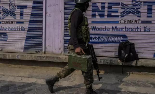 An Indian paramilitary soldier moves towards the site of a gun battle, in Srinagar, Indian controlled Kashmir, Saturday, Nov. 2, 2024. (AP Photo/Mukhtar Khan)