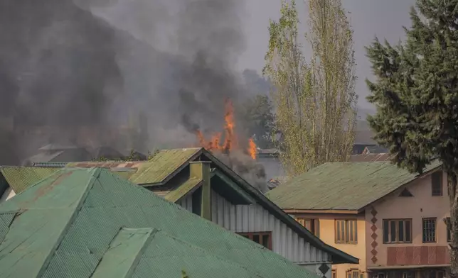 Flames and smoke billows from a residential building where militants are suspected to have taken refuge during a gun battle, in Srinagar, Indian controlled Kashmir, Saturday, Nov. 2, 2024. (AP Photo/Mukhtar Khan)