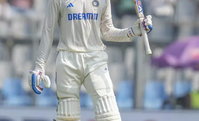 India's Shubman Gill raises his bat as he celebrates after scoring fifty runs during the second day of the third cricket test match between India and New Zealand at Wankhede Stadium, in Mumbai, India, Saturday, Nov. 2, 2024.(AP Photo/Rajanish Kakade)