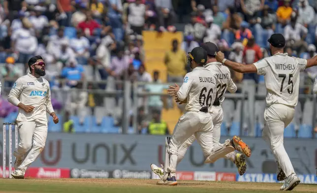 New Zealand's Aijaz Patel, left, celebrates the dismissal of India's Washington Sundar during the third day of the third cricket test match between India and New Zealand at Wankhede Stadium, in Mumbai, India, Sunday, Nov. 3, 2024.(AP Photo/Rajanish Kakade)